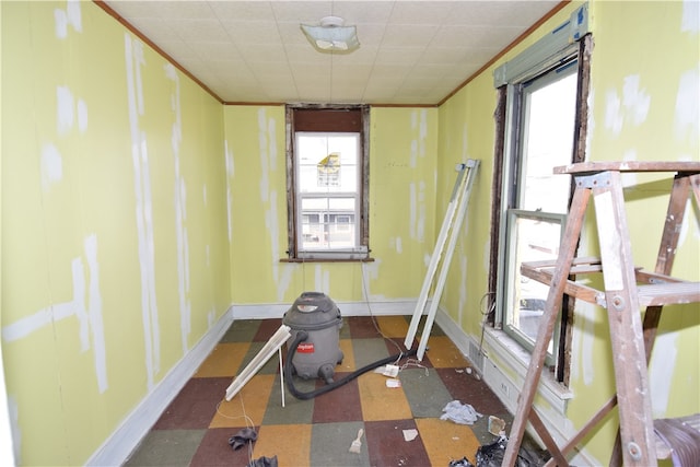 workout room featuring crown molding