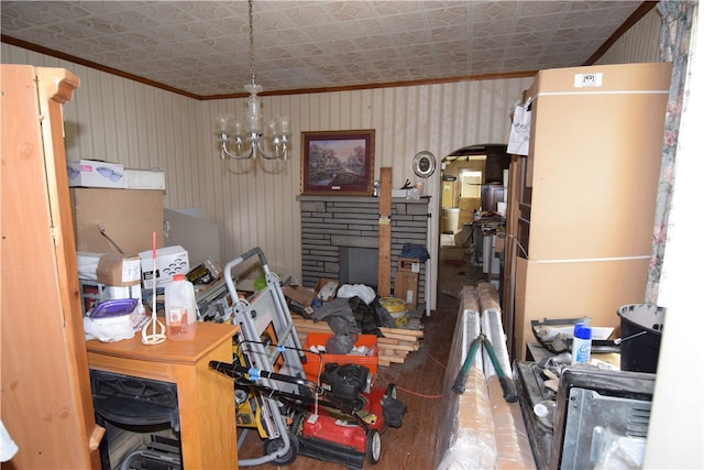 interior space with ornamental molding, a chandelier, and a fireplace