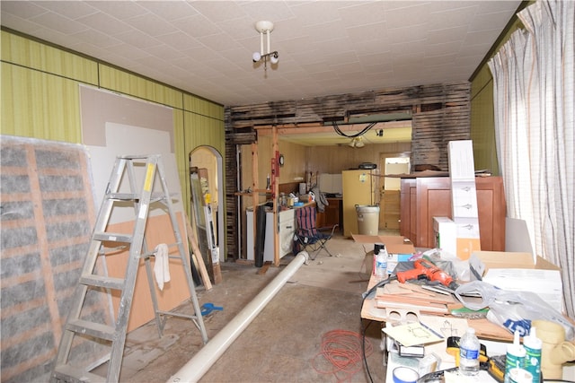 interior space featuring wooden walls and concrete flooring