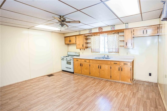 79-81 Lower Clinton St, Canoe/Banks Twps, PA 15772 - kitchen featuring white gas range oven, open shelves, a sink, light wood-type flooring, and ceiling fan