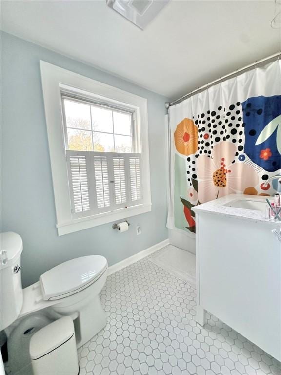 full bathroom featuring tile patterned flooring, vanity, shower / bath combo, and toilet