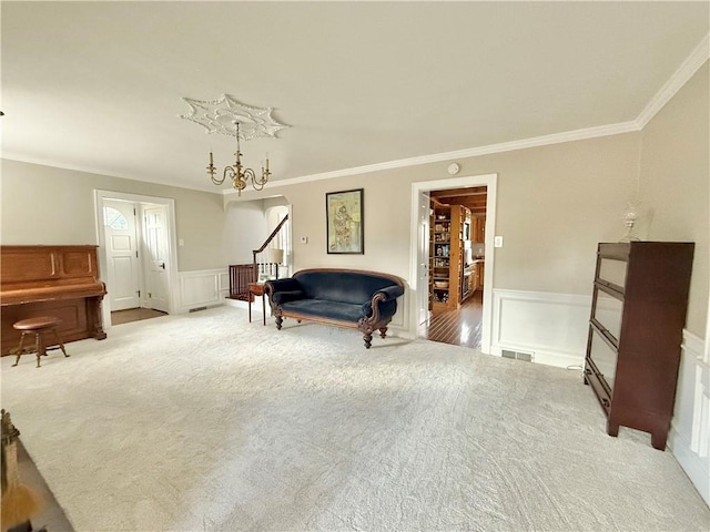 living area featuring crown molding and carpet flooring