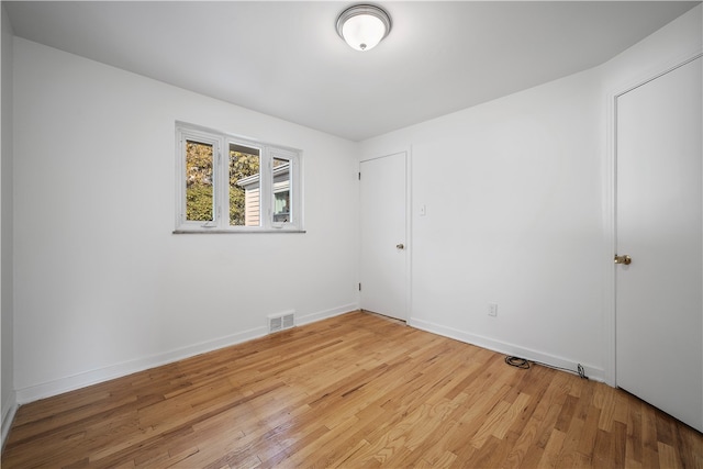 unfurnished room with light wood-type flooring