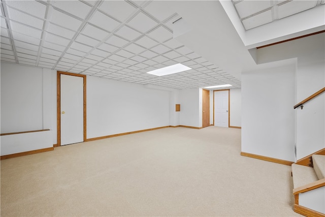 basement featuring light carpet