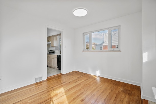 empty room with light hardwood / wood-style floors and sink