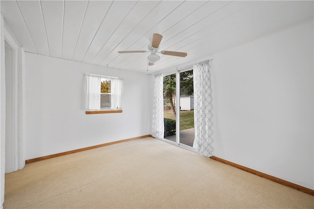 empty room featuring ceiling fan, carpet floors, and wooden ceiling