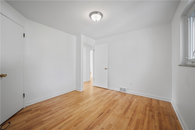 spare room featuring light hardwood / wood-style floors