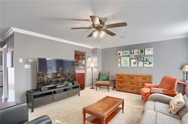 carpeted living room with ornamental molding and ceiling fan