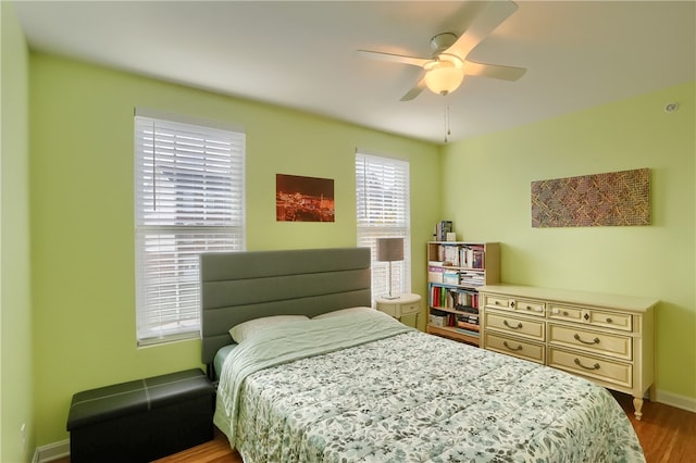 bedroom with ceiling fan and wood-type flooring