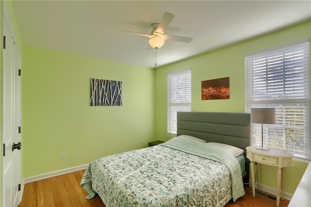 bedroom with hardwood / wood-style flooring and ceiling fan