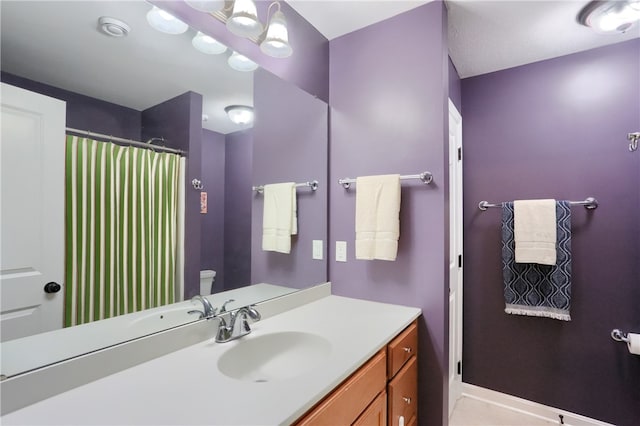 bathroom with vanity, toilet, and walk in shower