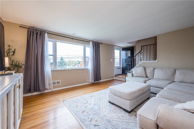 living room featuring light hardwood / wood-style flooring and a healthy amount of sunlight