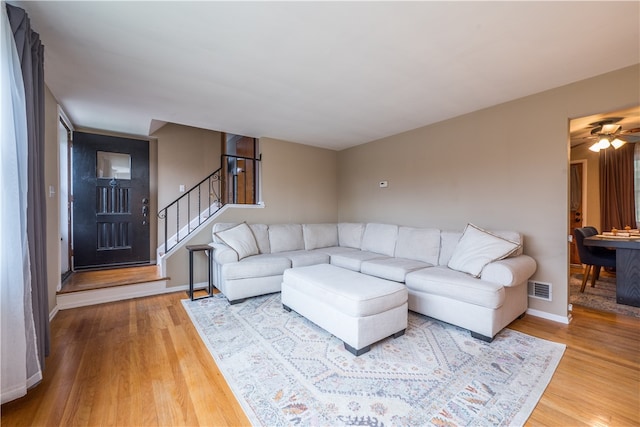 living room with wood-type flooring and ceiling fan