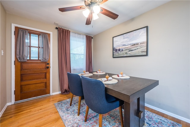 dining area with light wood-type flooring, plenty of natural light, and ceiling fan