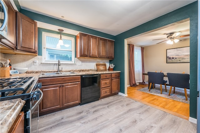 kitchen with sink, dishwasher, light wood-type flooring, stainless steel gas stove, and decorative backsplash