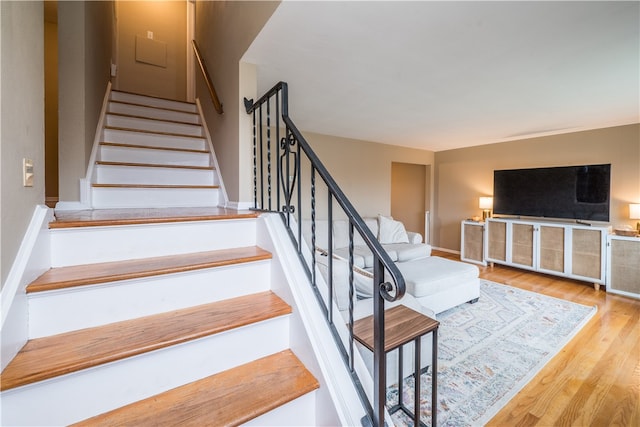 staircase featuring wood-type flooring