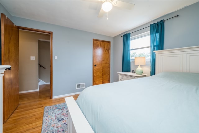 bedroom with light hardwood / wood-style floors and ceiling fan