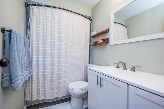 bathroom featuring vanity, a shower with curtain, and toilet