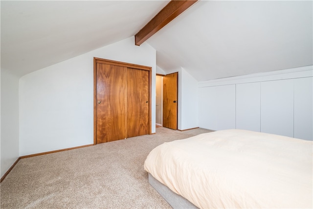 bedroom featuring a closet, light carpet, and lofted ceiling with beams