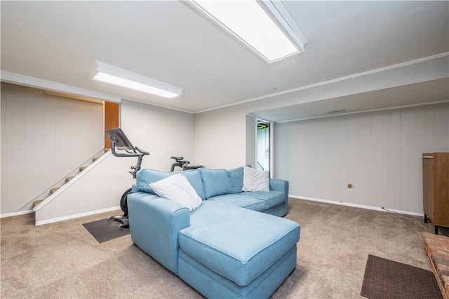 carpeted living room featuring crown molding and wood walls