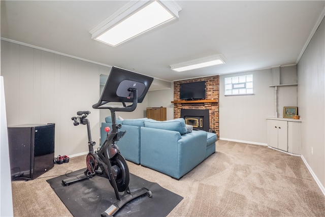 exercise area with ornamental molding, light carpet, and a fireplace