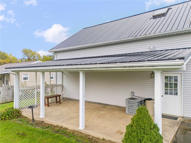 rear view of property with a patio and central AC unit