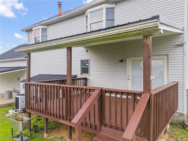 back of property featuring central air condition unit and a deck