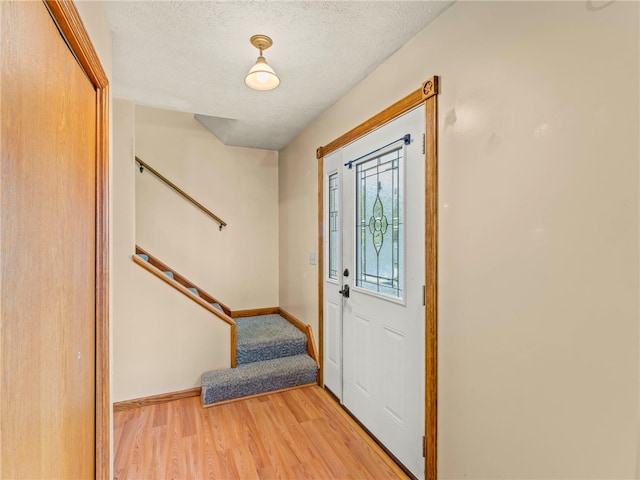 entryway featuring a textured ceiling and light wood-type flooring