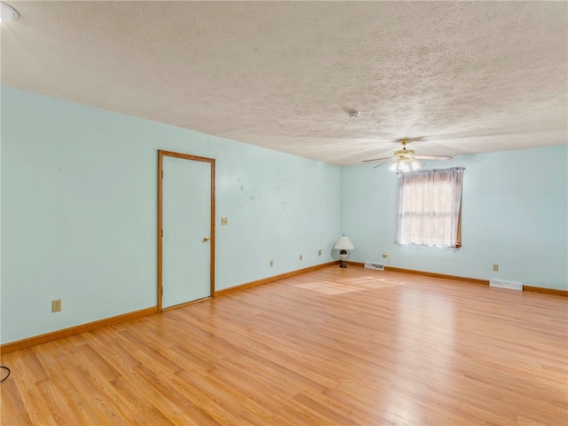 empty room featuring ceiling fan, a textured ceiling, and light hardwood / wood-style flooring