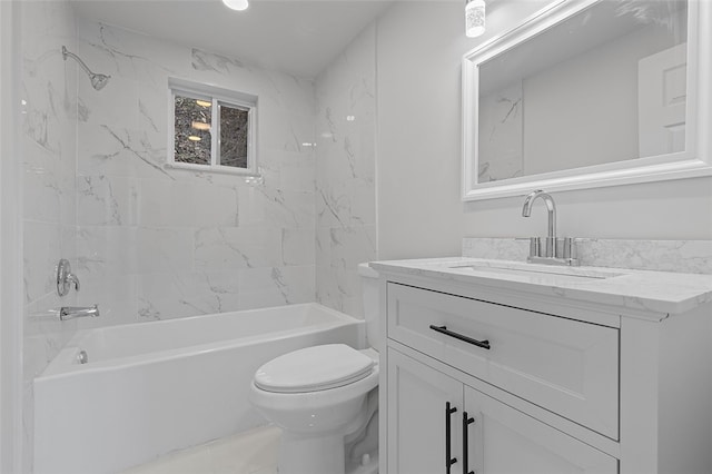 full bathroom featuring tiled shower / bath, vanity, and toilet