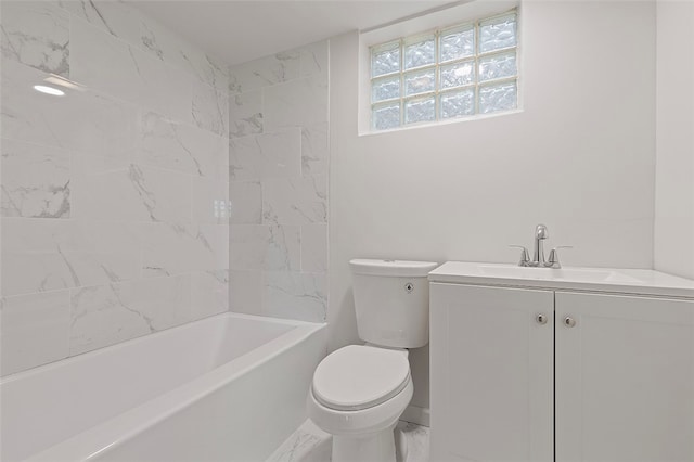 full bathroom featuring tiled shower / bath, vanity, and toilet