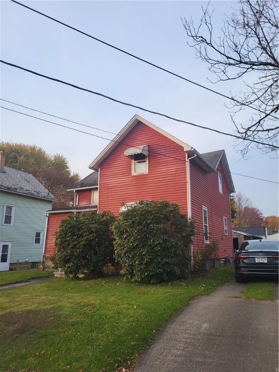 view of property exterior featuring a lawn