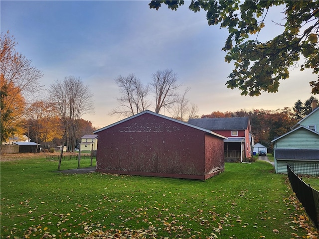 property exterior at dusk featuring a lawn