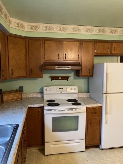 kitchen with sink and white appliances