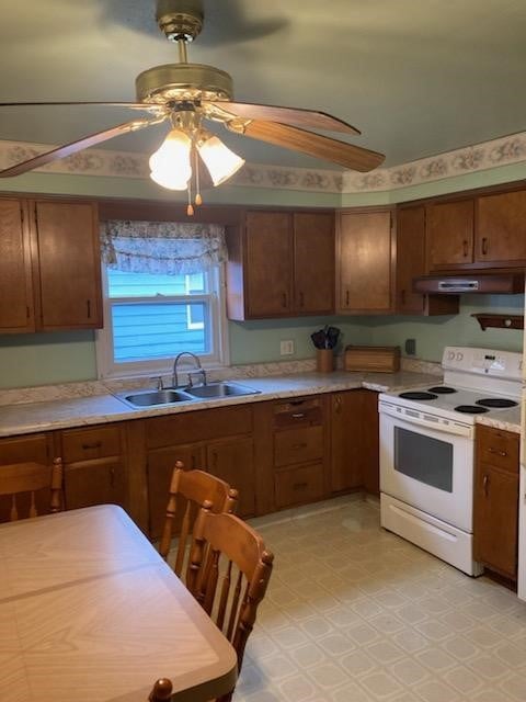 kitchen with electric stove, sink, and ceiling fan