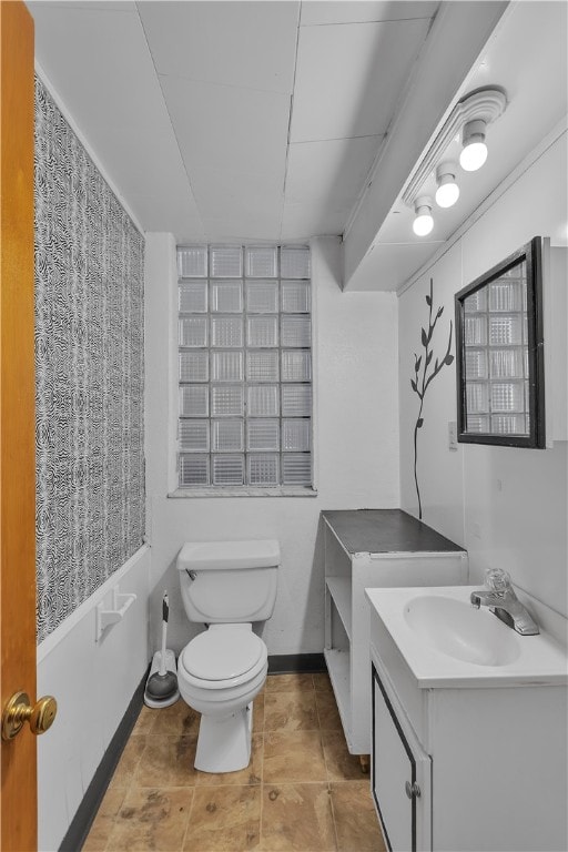 bathroom featuring toilet, vanity, and tile patterned flooring