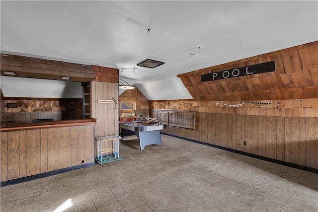 interior space featuring wooden walls and vaulted ceiling