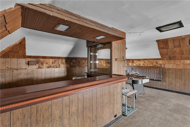 kitchen with wood walls and wooden ceiling