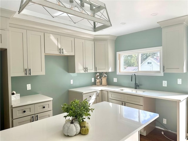 kitchen with hardwood / wood-style flooring, white cabinetry, and sink