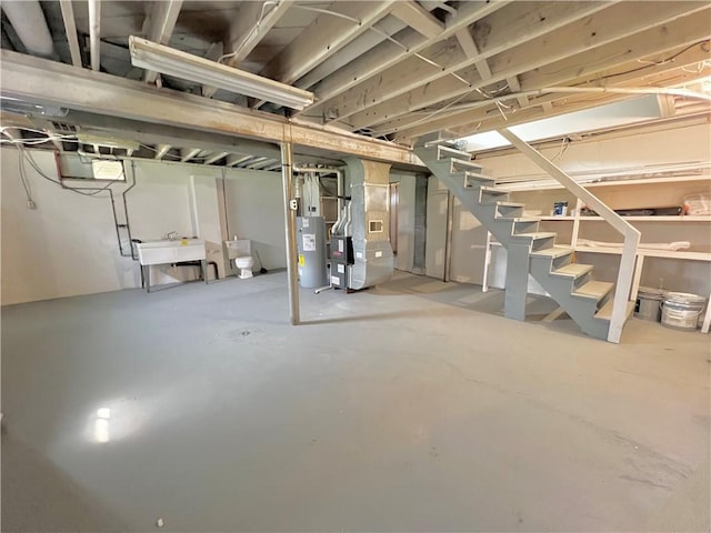 basement with heating unit, water heater, and sink