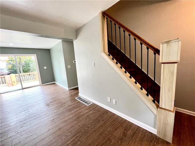 stairway with hardwood / wood-style flooring