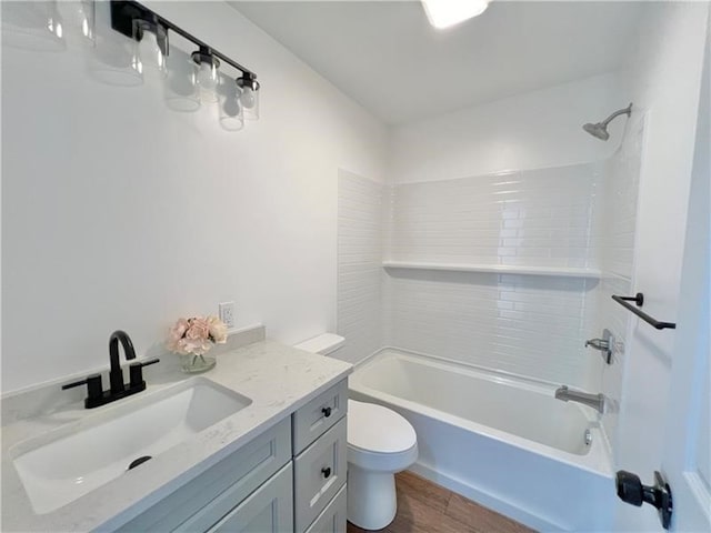 full bathroom with hardwood / wood-style floors, vanity, toilet, and tub / shower combination