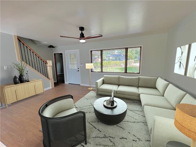 living room featuring hardwood / wood-style floors and ceiling fan