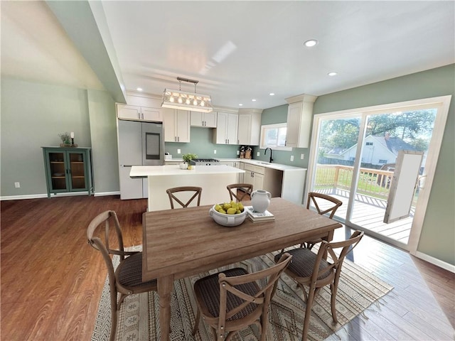 dining room featuring hardwood / wood-style floors and sink