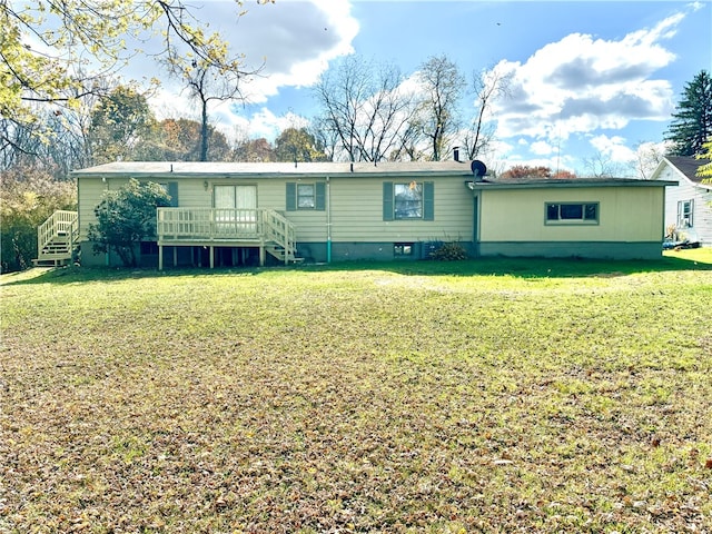 back of house featuring a wooden deck and a lawn