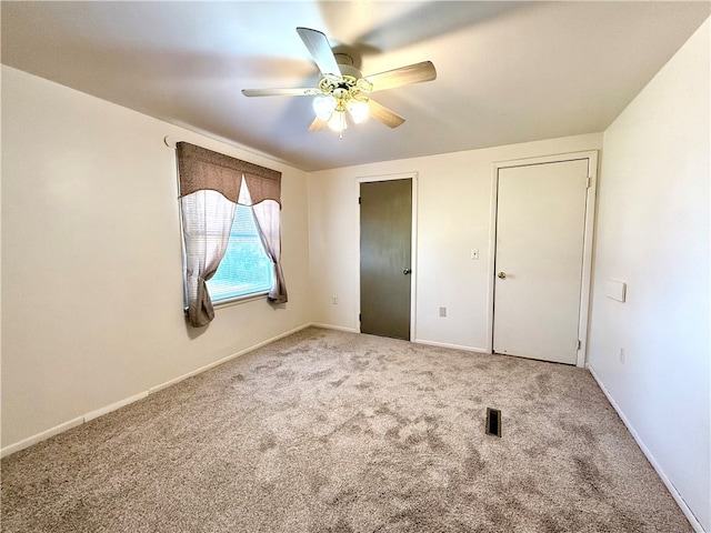 unfurnished bedroom featuring carpet and ceiling fan