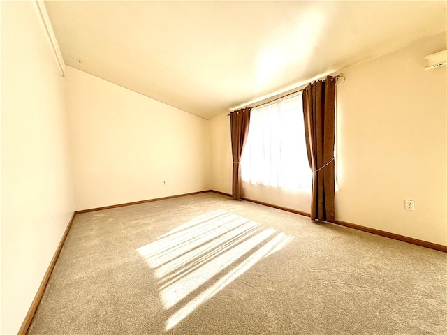 empty room featuring lofted ceiling and carpet flooring