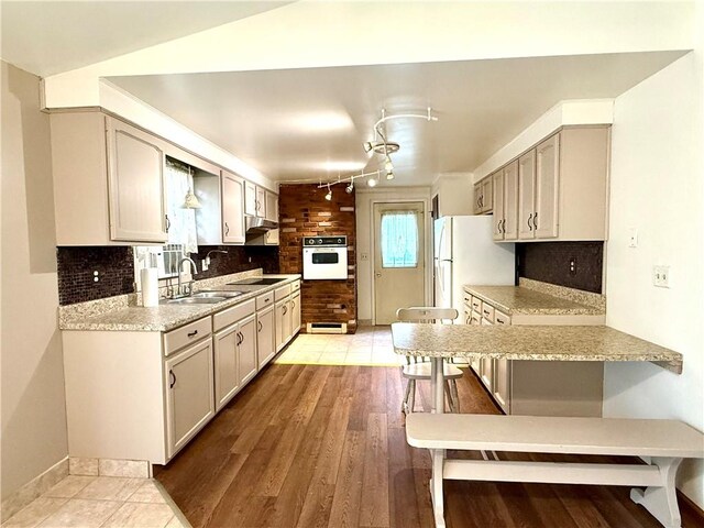 226 Cottage Ave, Masontown, PA 15461 - kitchen featuring white appliances, a sink, light countertops, and backsplash