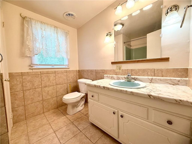 226 Cottage Ave, Masontown, PA 15461 - full bath featuring tile patterned flooring, tile walls, vanity, toilet, and wainscoting