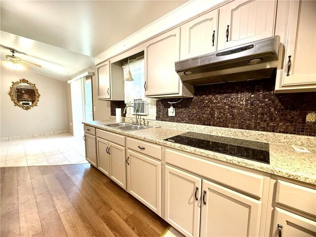 226 Cottage Ave, Masontown, PA 15461 - kitchen featuring under cabinet range hood, a sink, black electric stovetop, ceiling fan, and tasteful backsplash